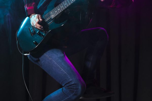 artist-playing-guitar-jumping-sideways